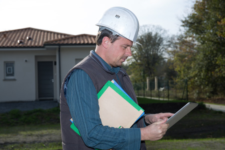 Engineer looking at his tablet at a construction siteの写真素材