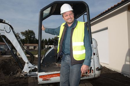 Man Worker operating a crane at a construction site