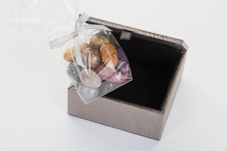 Small colorful chocolate stones on grey box