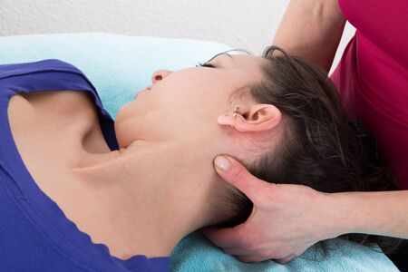 Neck massage for young woman relaxing in a spa salonの写真素材