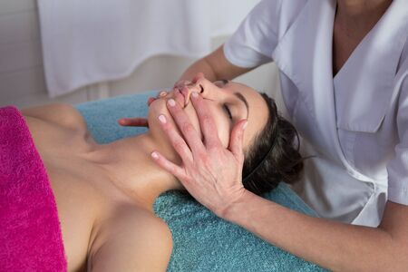 Face Massage.  Close-up of a Young Woman Getting Spa Treatment.