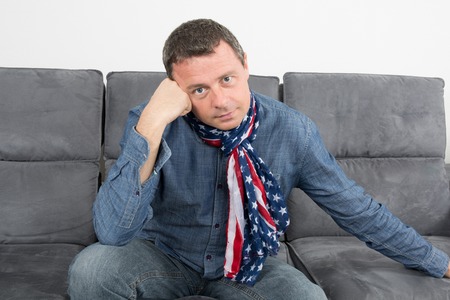 Closeup portrait of trendy guy wearing scarf, looking at camera.の写真素材