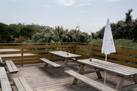 Street view of a coffee terrace with tables and chairsの写真素材