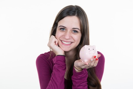 Young woman with piggy bank isolated on white backgroundの写真素材