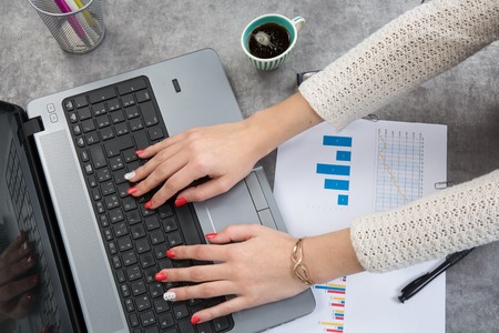 Notes manager's office at the workplace - notebook in the hands of womenの写真素材