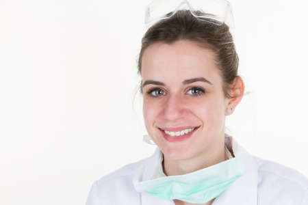 Smiling woman lab technician holding goggles and maskの写真素材