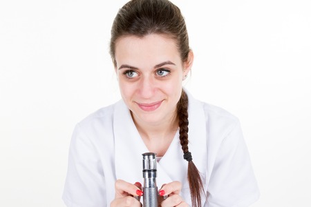Female scientist looking through a microscope in laboratory