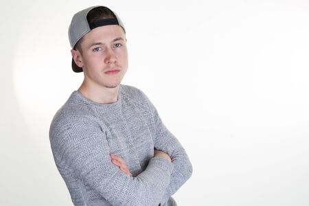 Guy in a vest and a baseball cap on white background