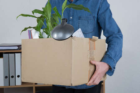 Redundant Businessman Carrying Possessions In Boxの写真素材
