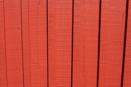 Orange paint coated wooden pine boards lying in a row as a close-up background compositionの写真素材