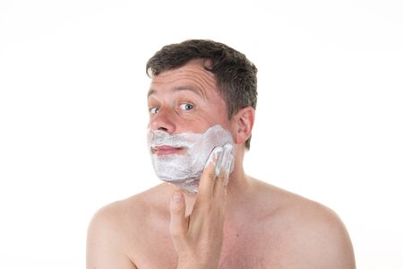 Handsome man in his bathroom shaving in the morning