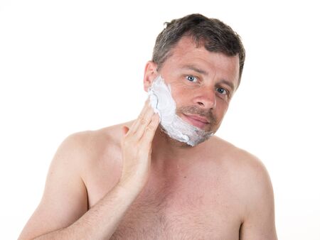 Handsome man in his bathroom shaving in the morningの写真素材