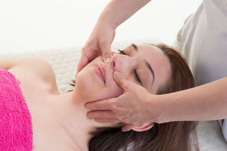 Face Massage.  Close-up of a Young Woman Getting Spa Treatment.の写真素材