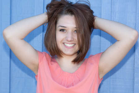 Attractive caucasian smiling woman brunette with hands hair