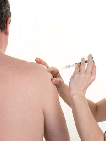 Woman doctor gets an injection to a manの写真素材