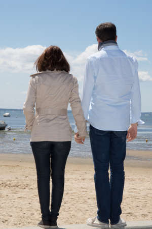 Happy couple on beach, attractive people standingの写真素材