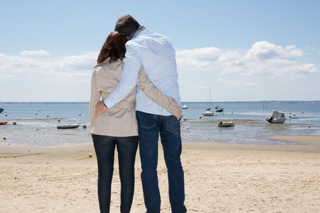 Happy couple on beach, attractive people standingの写真素材