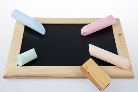 Small school wooden blank blackboard and chalksの写真素材