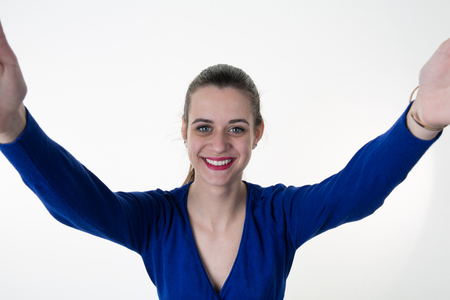 Portrait of a young attractive woman making selfie photo smartphoneの写真素材