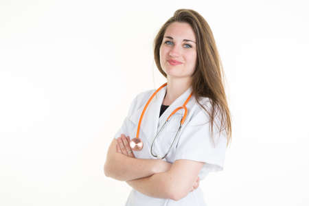 Female doctor standing with her arms crossed isolatedの写真素材