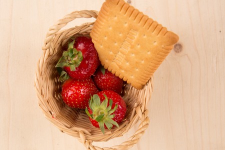 strawberries in natural background with cake for tea timeの写真素材