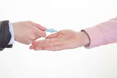 business concept - businessman and businesswoman holding puzzle pieces in officeの写真素材