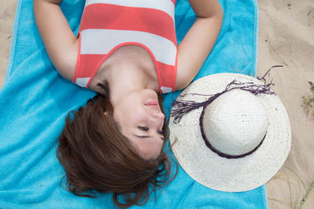 Flat lay, woman with hat beach sand in a summerの写真素材