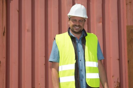 Dock worker supervisor checking containers dataの写真素材