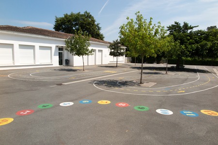 Preschool building exterior with playground on a sunny dayの写真素材