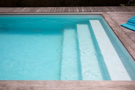 Outdoor in ground residential swimming pool in backyardの写真素材