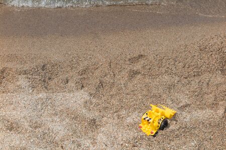 Children's beach toys on sand on a sunny dayの写真素材