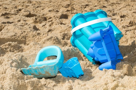 Beach toys in the sand summertime holidays at the seaの写真素材