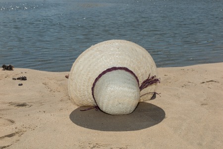 Summer vacation woman on the beach in beach hat enjoying summer holidays looking at the oceanの写真素材