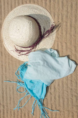 straw hat and blue dress at the beach in summer.の写真素材