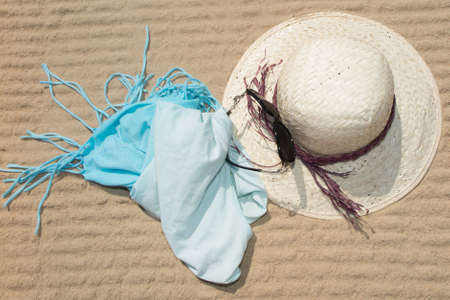 straw hat and blue dress at the beach in summer.の写真素材