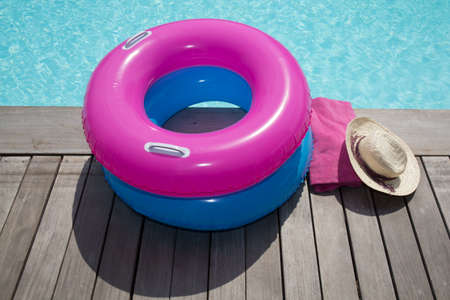 Pool ring and swimming pool on wooden deck summertimeの写真素材