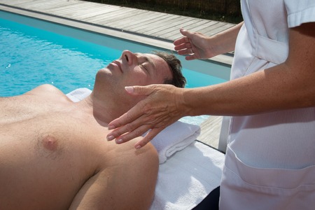 Reiki healer doing reiki treatment to a manの写真素材