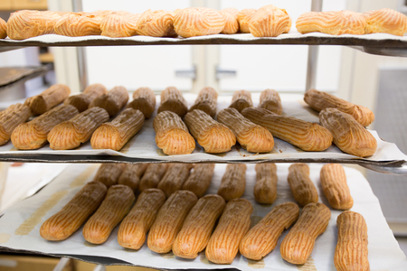 Shelves with baked French baguettes at bakery displayの写真素材