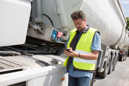 Logistic concept with businessman holding digital tablet use for import, export and logistic background.の写真素材
