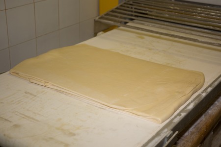 Fresh prepared dough on a wooden board, close upの写真素材