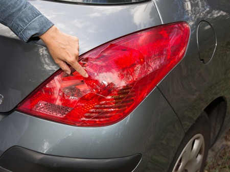 Grey car with damaged headlamp after collisionの写真素材