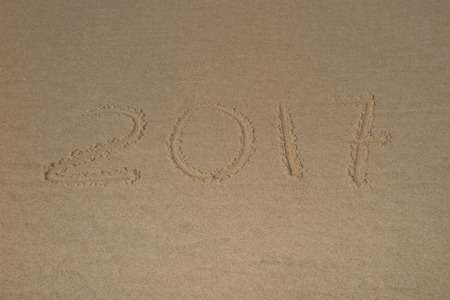 2017, a message written in the sand at the beach.の写真素材