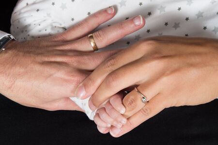 Family Baby Hands. Father and Mother Holding Newborn Kid.の写真素材