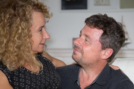 Mature couple looking at each other at homeの写真素材