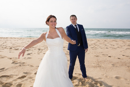 marriage on the ocean beach in summer with couple in loveの写真素材