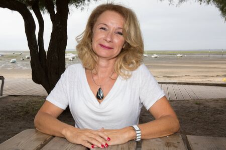 pretty senior woman holidays in town beach on summerの写真素材