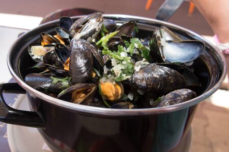 A large black meat dish mussels for one person in the restaurantの写真素材