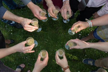 guests put themselves in circles and toast together with their glassesの写真素材