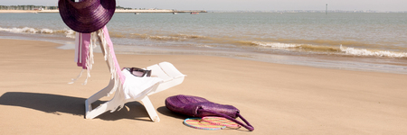 Panoramic view representing the holidays with the beach seat the towel the hat in front of the seaの写真素材