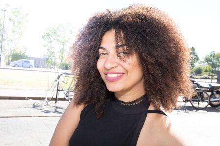 pretty mixed american woman in tonw with large smileの写真素材